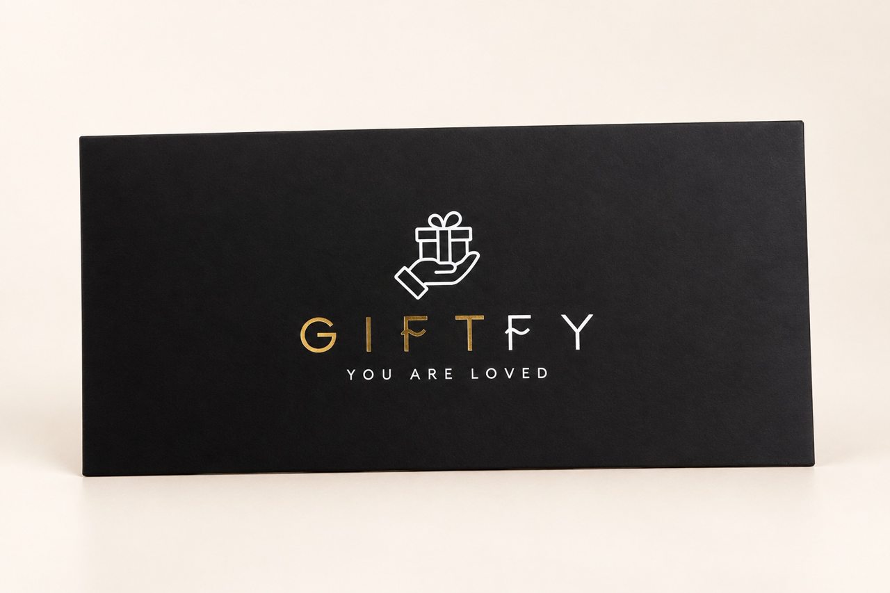 Black GIFTFY personalized welcome envelope with gold and white branding